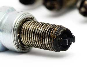 carbon on spark plugs cause